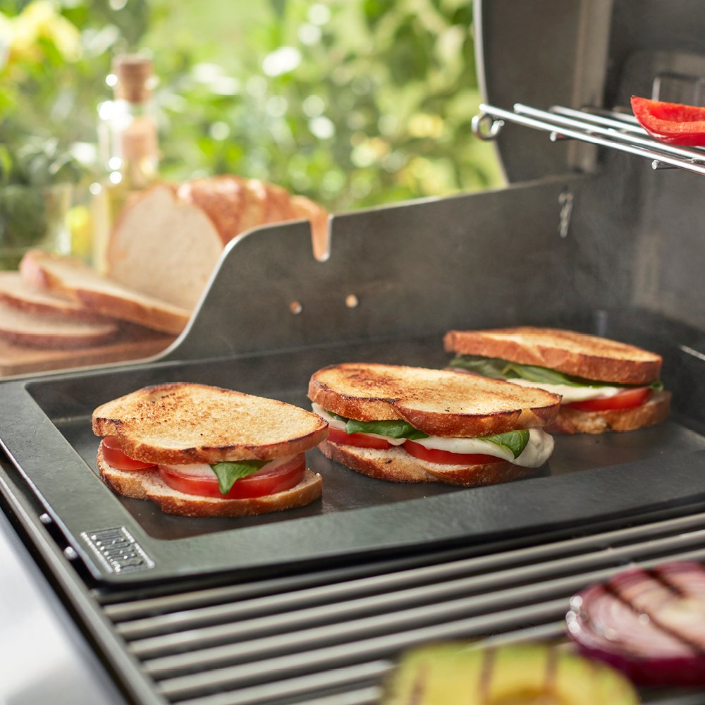 Weber griddle cooking pancakes in use illustrating even heat retention for consistent browning