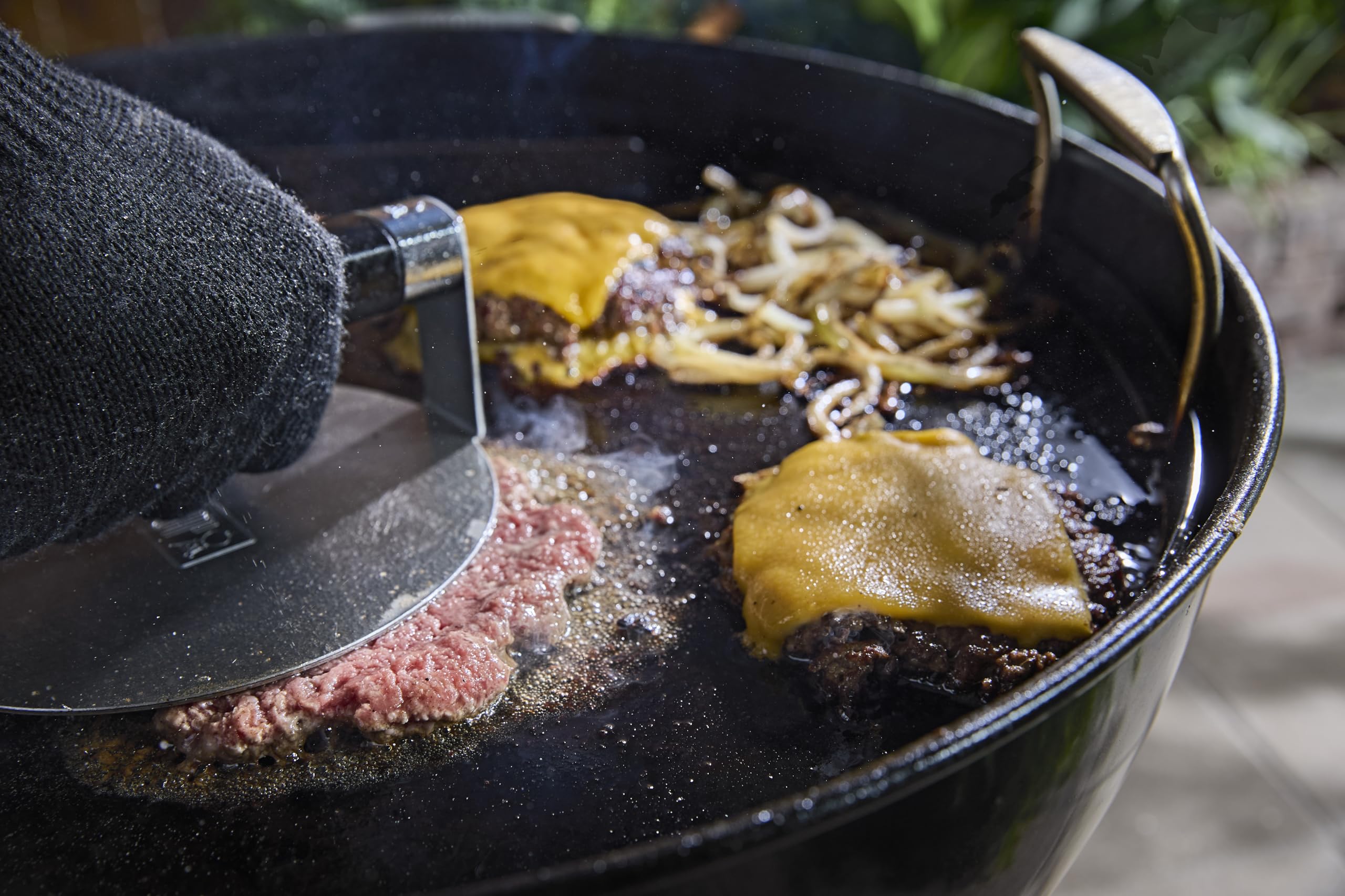 Weber griddle installed in 22" kettle illustrating expanded cooking capability benefit