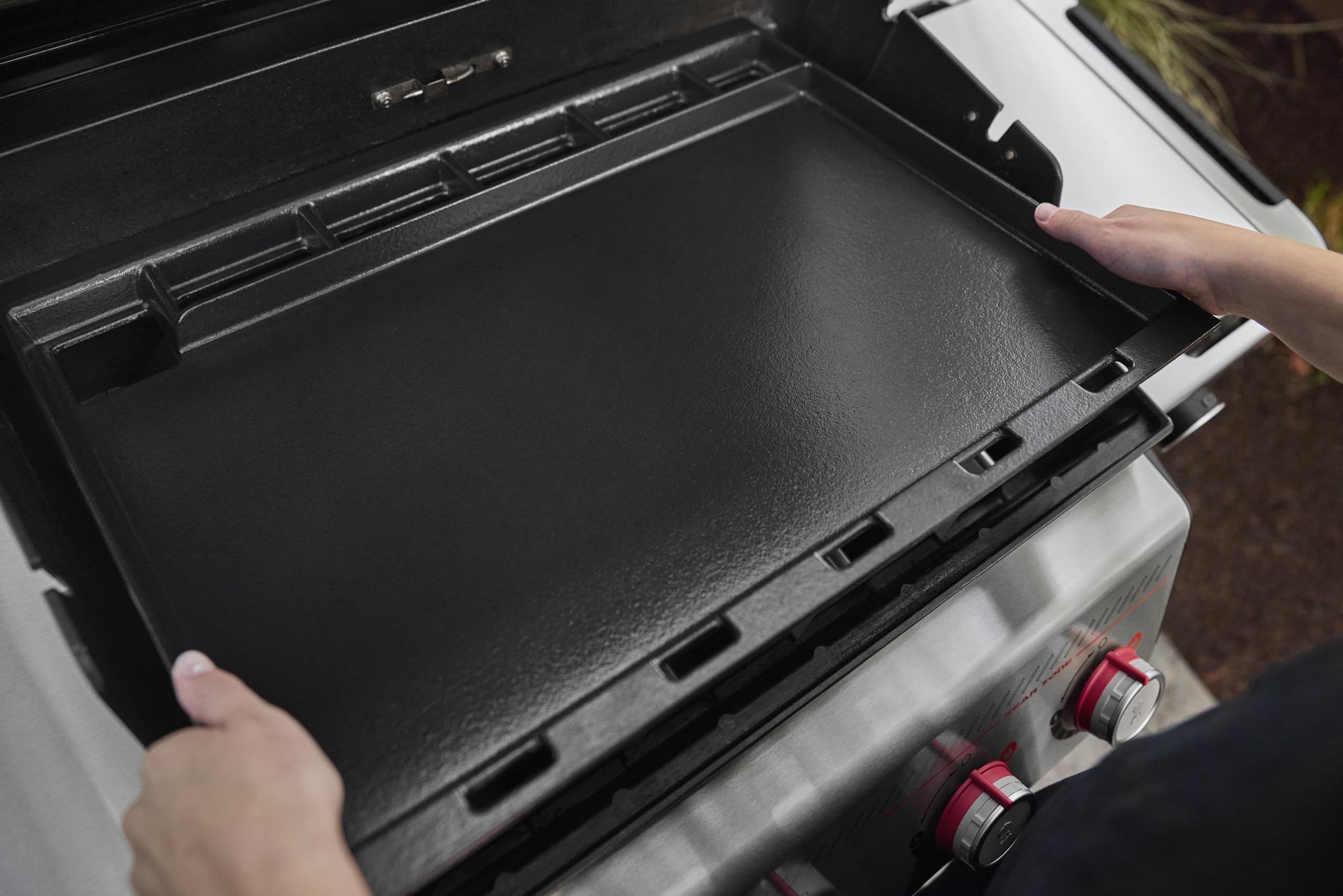 Weber griddle installed on a Spirit grill demonstrating easy conversion and expanded cooking area
