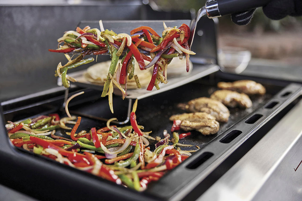 Weber griddle size and scale with spatula illustrating large cooking area