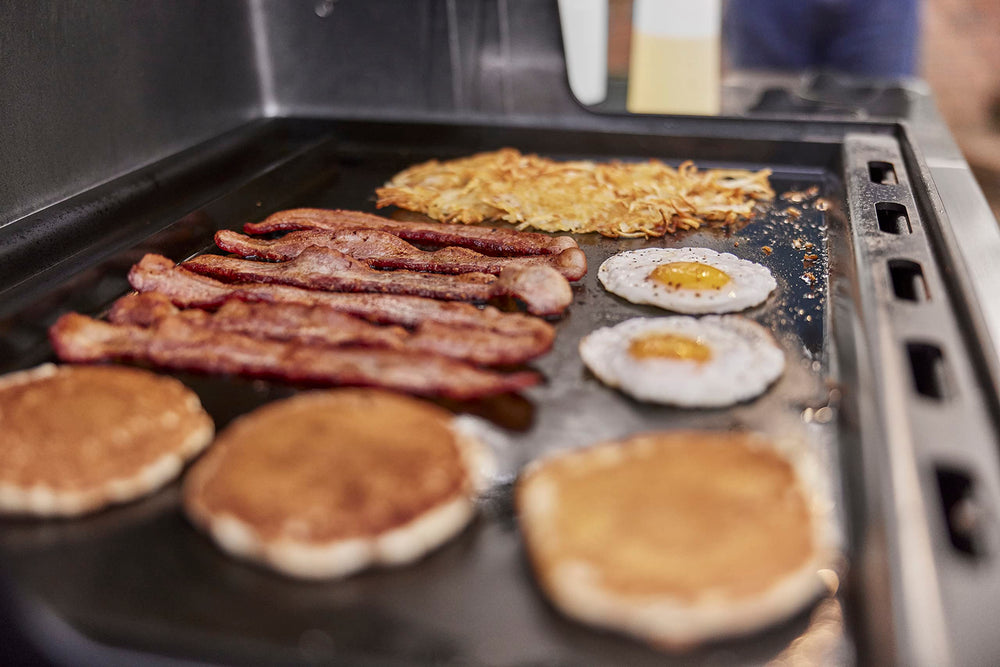 Weber griddle with size comparison to spatula showing full‑size capacity for family meals