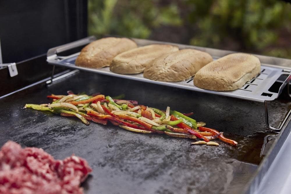 Weber warming rack handle and hang loop for secure grip and convenient storage by grill