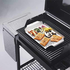 Weber grill pan beside hand to show size and wide carrying handles for safe transport
