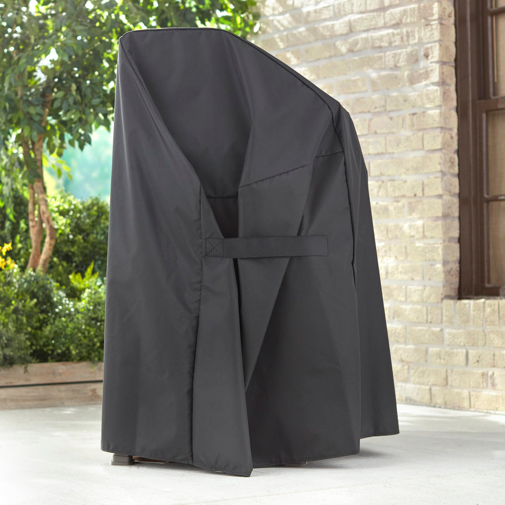 Weber cover with fastening straps secured demonstrating wind protection benefit