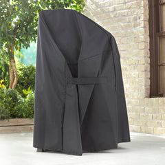 Weber cover with fastening straps secured demonstrating wind protection benefit