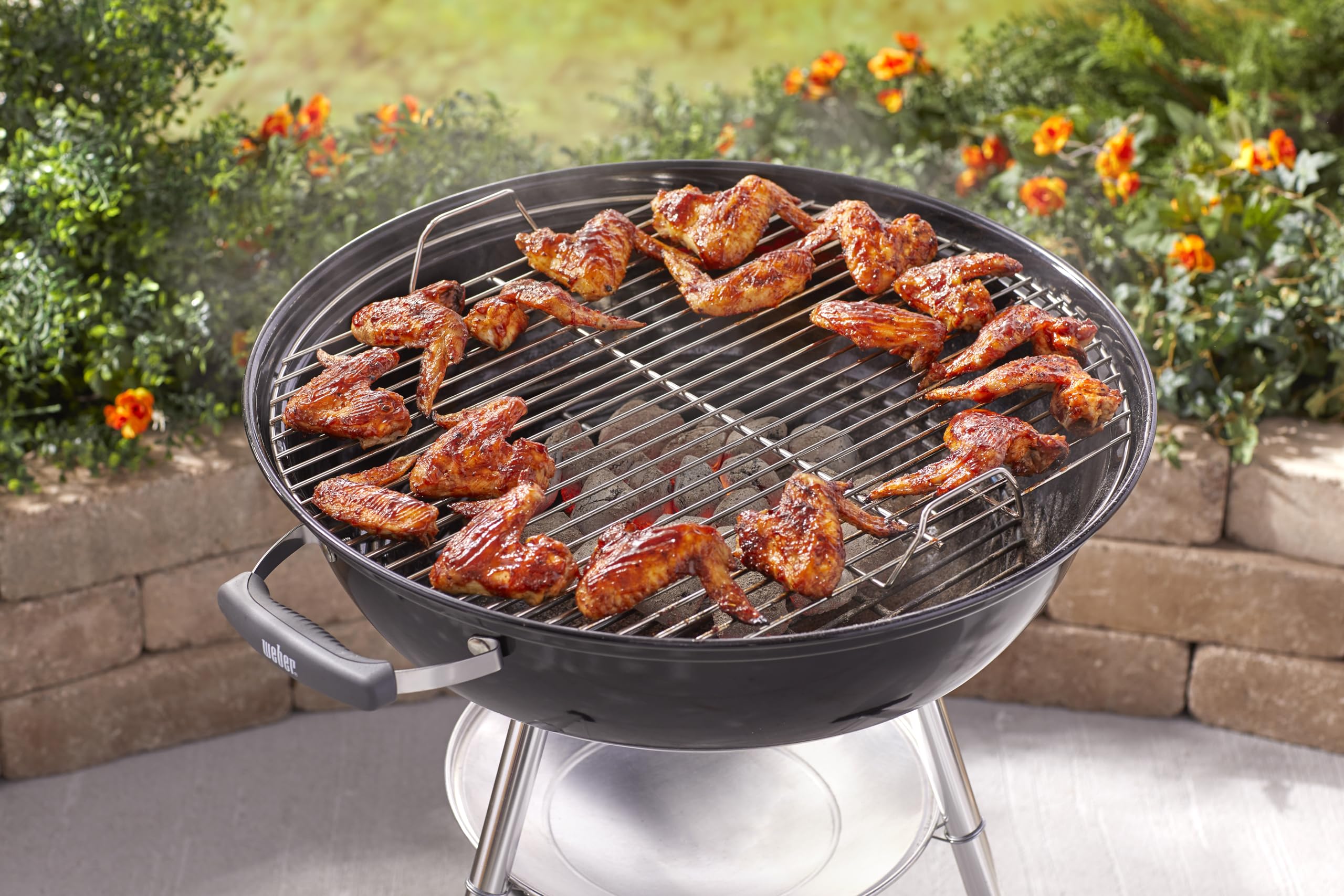 Weber Jumbo Joe grilling burgers on a patio showing flavorful charcoal results