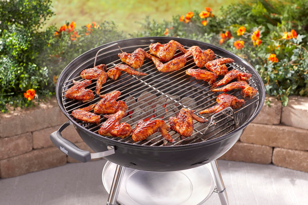 Weber Jumbo Joe grilling burgers on a patio showing flavorful charcoal results