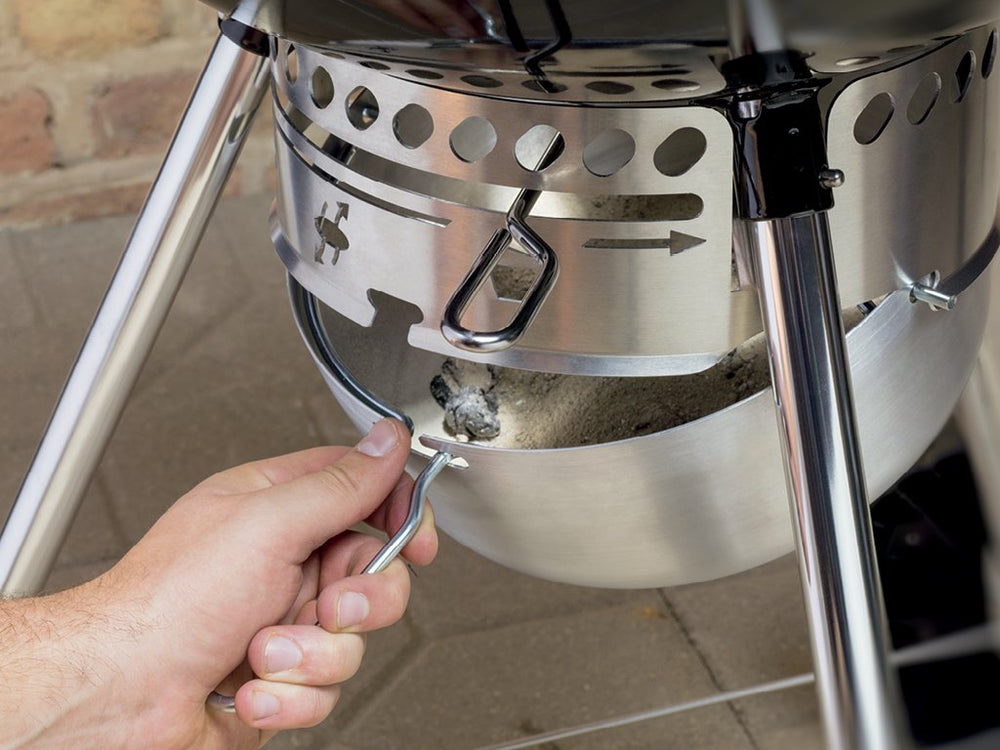 Weber kettle grilling burgers on grate showing ample cooking surface benefit