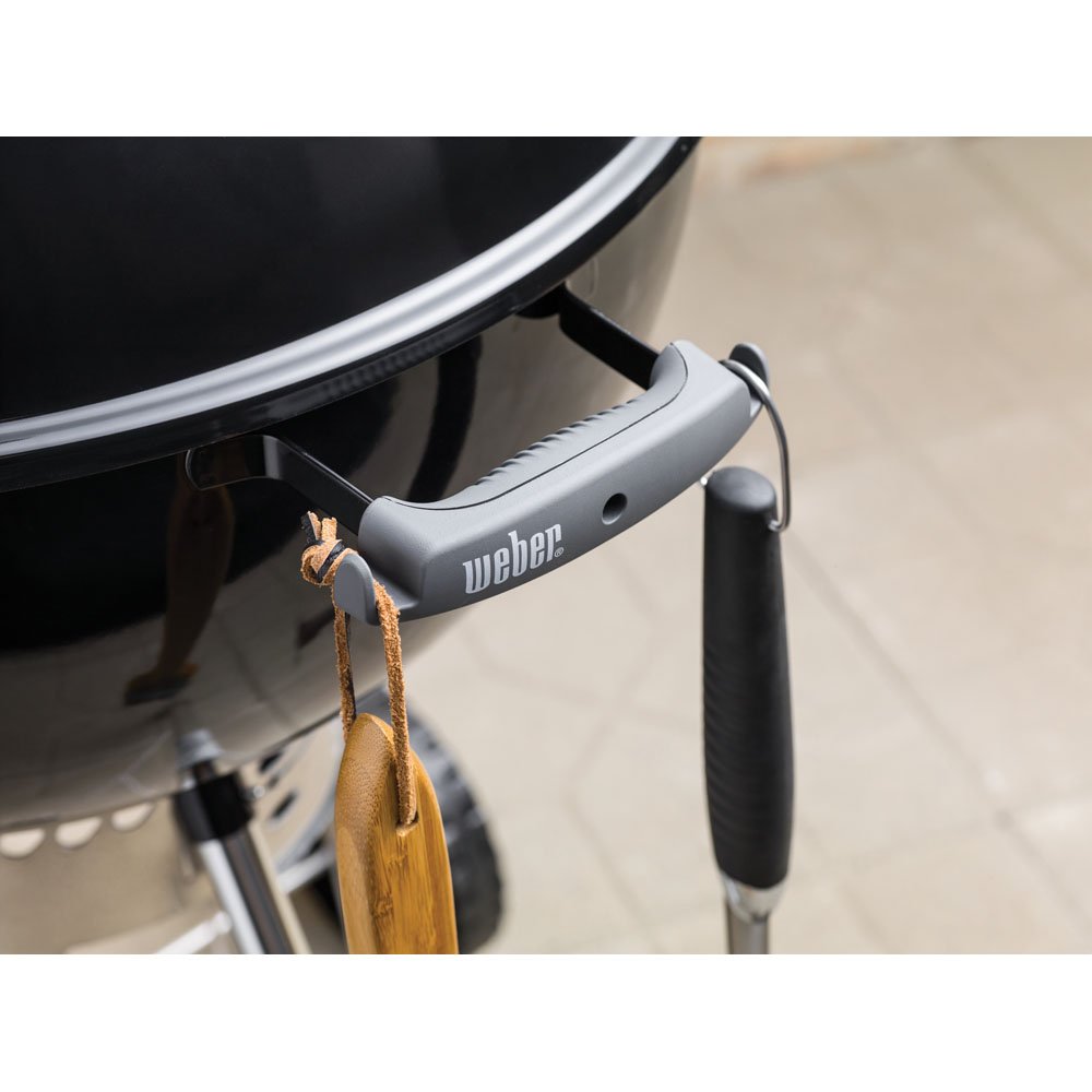 Weber close detail of hinged cooking grate showing easy charcoal access benefit