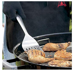 Weber locking tongs gripping steak on grill demonstrating one-handed lock and lift benefit