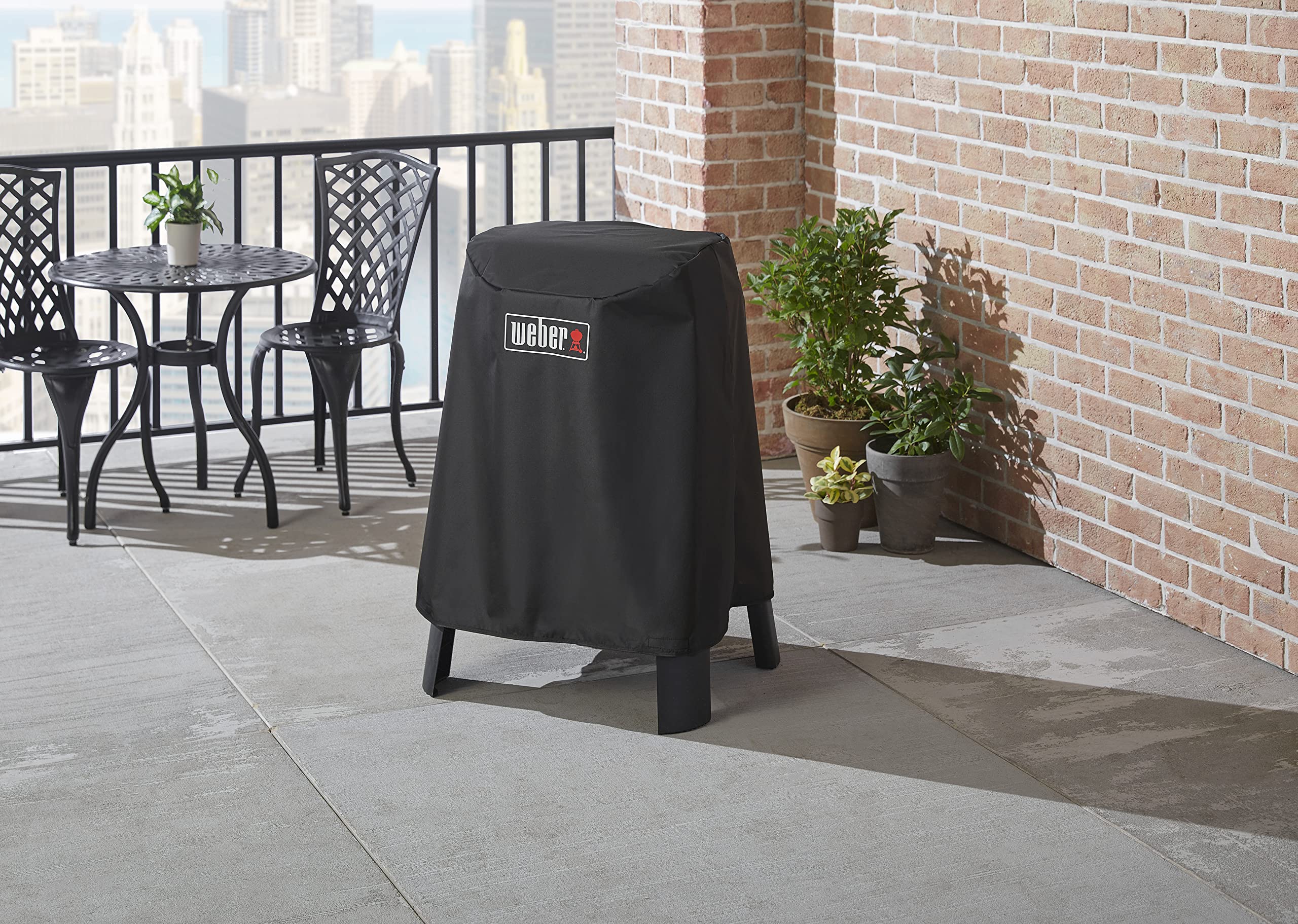 Weber Lumin cover in use on balcony protecting grill and stand from elements