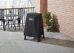 Weber Lumin cover in use on balcony protecting grill and stand from elements