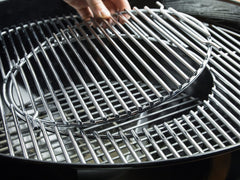 Weber Master-Touch hinged Gourmet BBQ System grate open for easy charcoal access and inserts