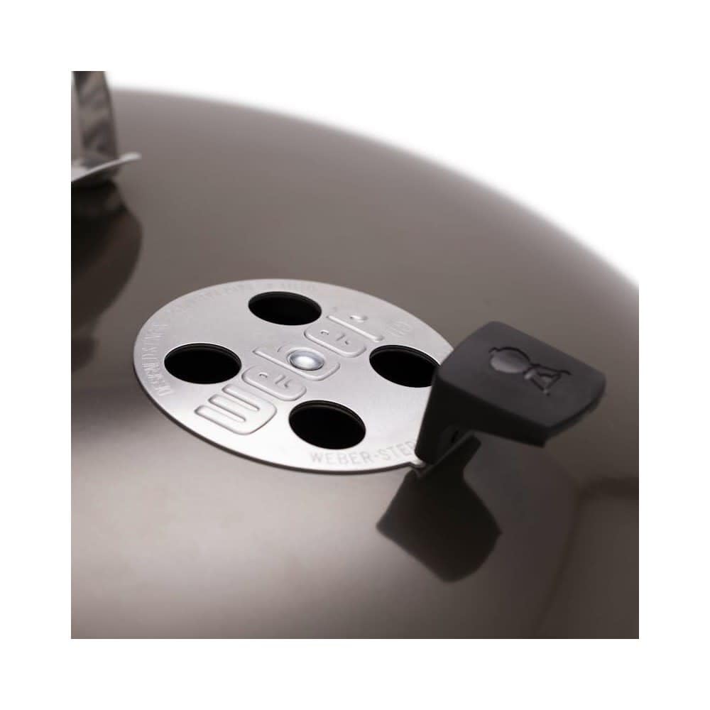 Weber Master-Touch beside chair showing scale and large 26-inch cooking capacity
