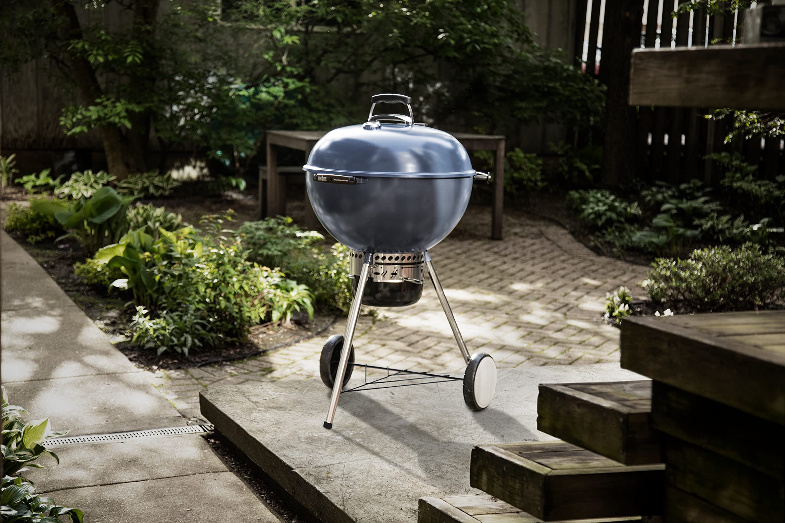 Weber Master-Touch tool hooks with spatula and tongs kept within reach for efficient grilling