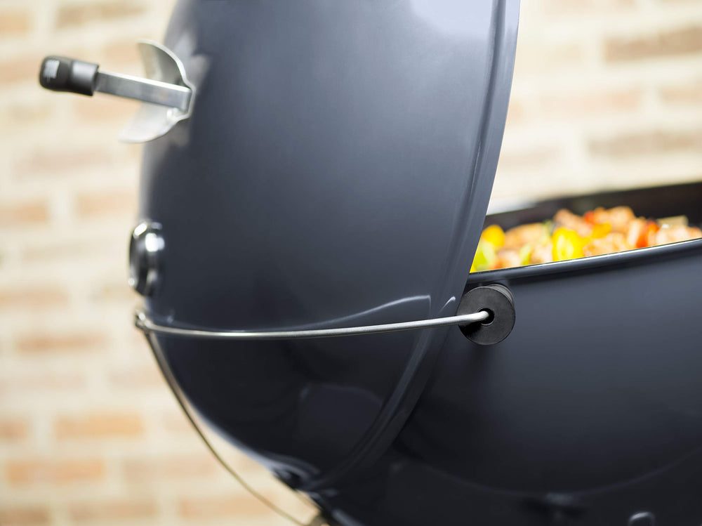 Weber Master-Touch Tuck-Away lid holder storing lid safely and keeping hands free while grilling