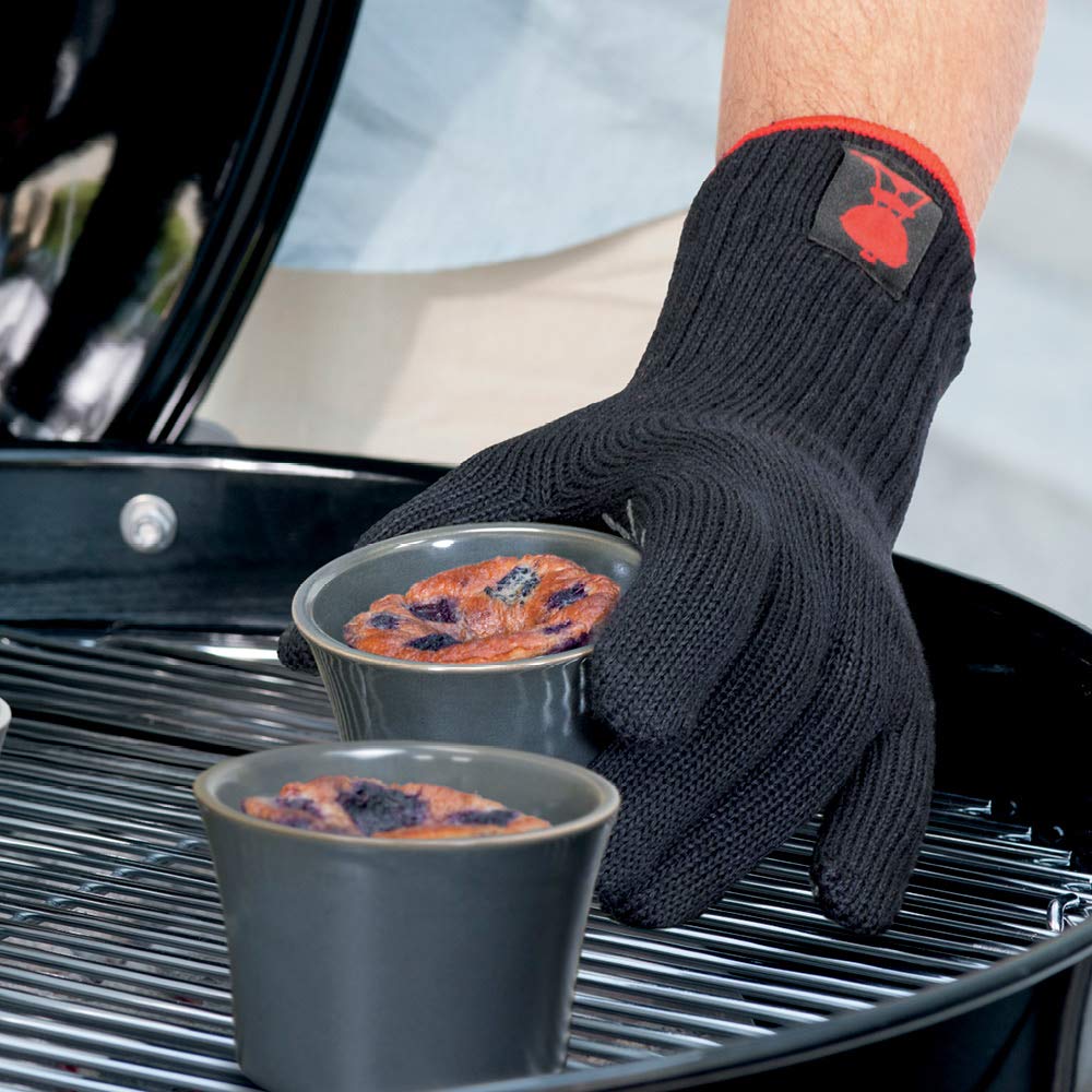Weber gloves lifting a hot grill lid demonstrating heat protection confidence