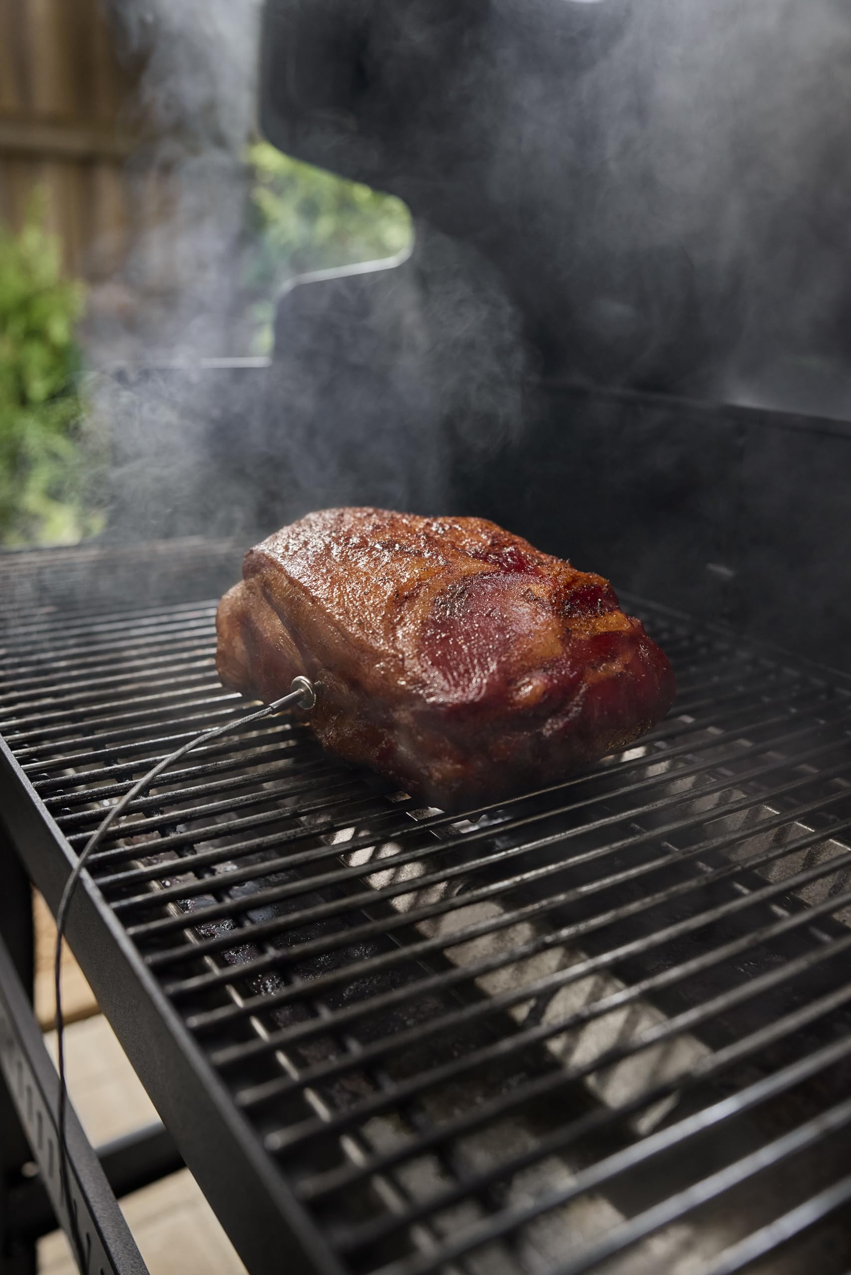 Weber probe inserted in roast inside smart grill showing real-time temperature monitoring