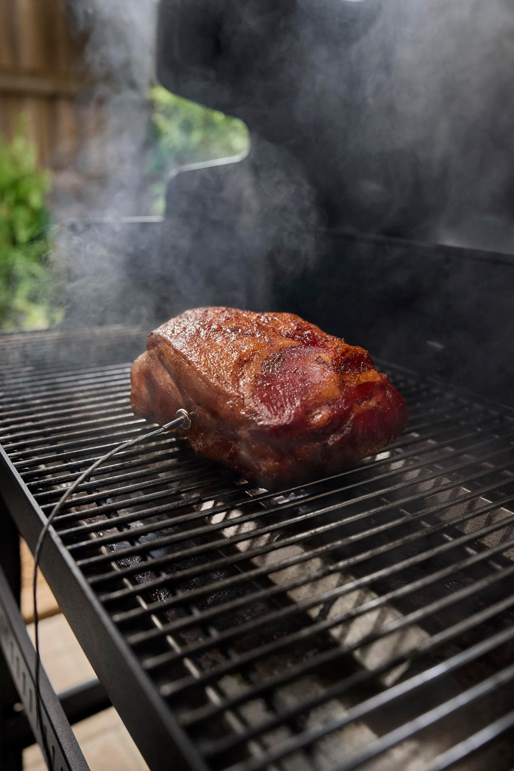 Weber probe inserted in roast inside smart grill showing real-time temperature monitoring