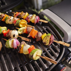 Weber Q 2800N+ open lid with whole chicken demonstrating high-dome capacity