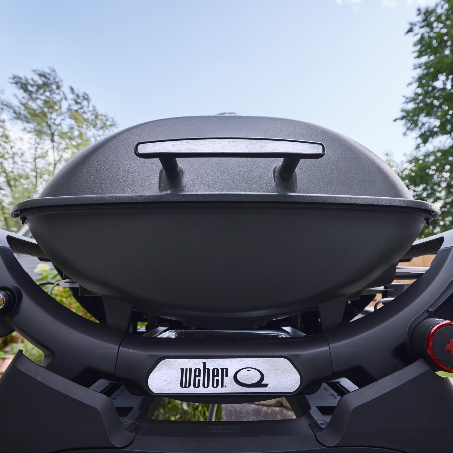 Weber Q 2800N+ side tables stowed in cradle for easy transport and storage