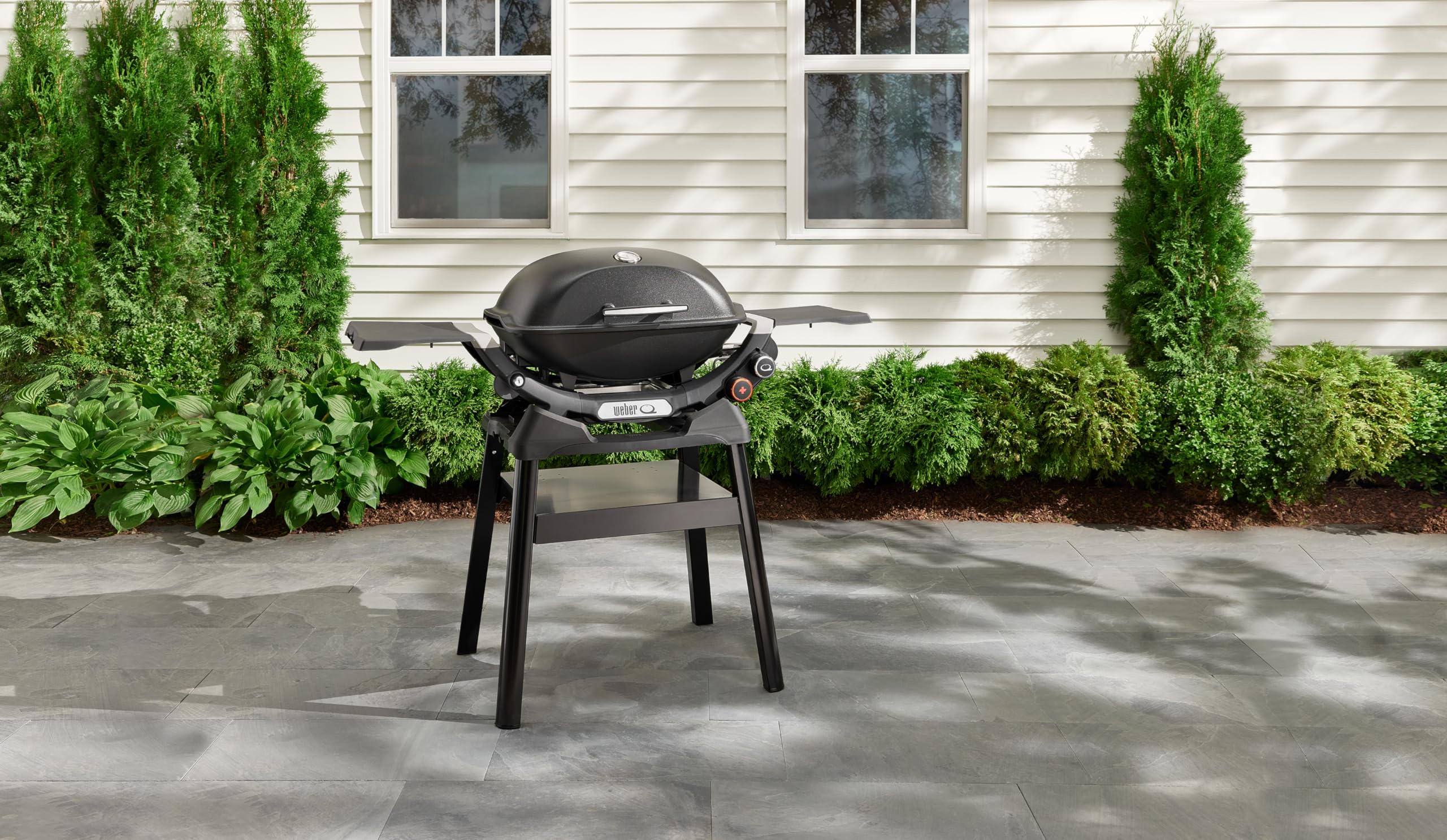 Weber compact stand close-up of built-in shelf holding tools for easy access