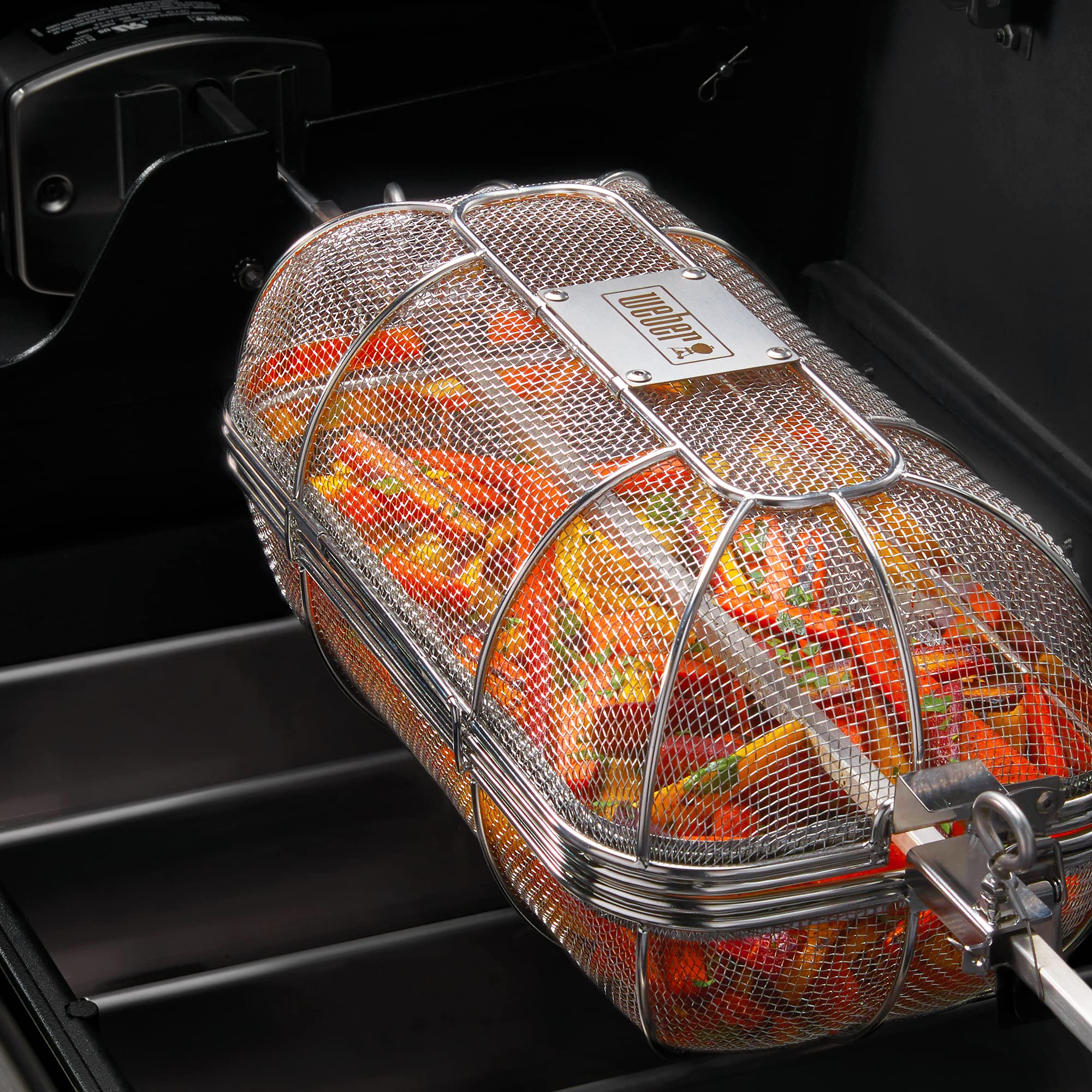 Weber basket with removable divider installed showing dual-compartment cooking advantage