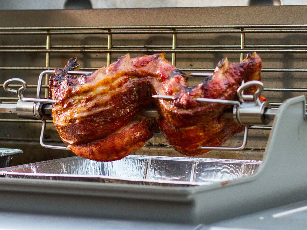 Weber rotisserie in backyard setting showing social grilling and entertaining benefit