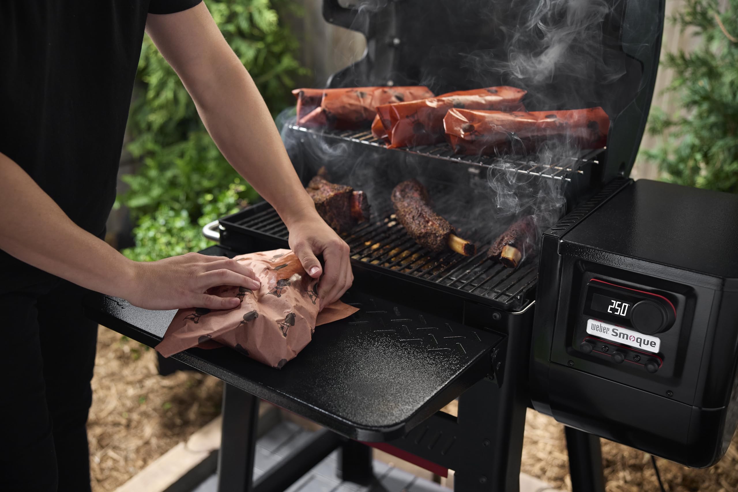 Weber Searwood table beside cutting board illustrating generous workspace advantage