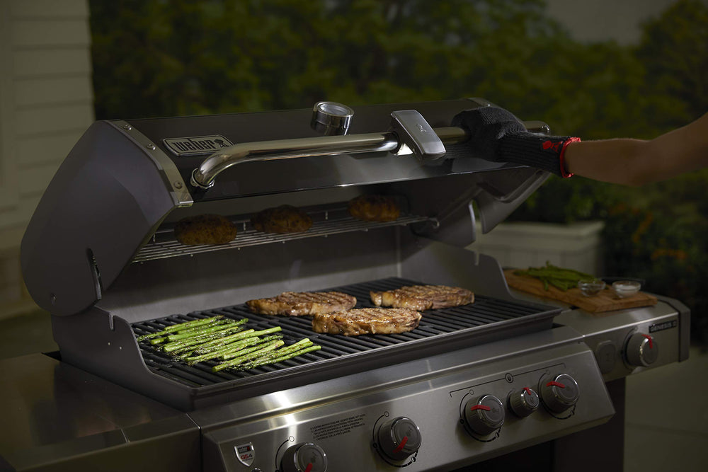 Weber size comparison beside spatula showing compact scale advantage