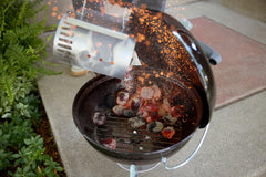 Weber Smokey Joe in use at tailgate demonstrating portability and performance
