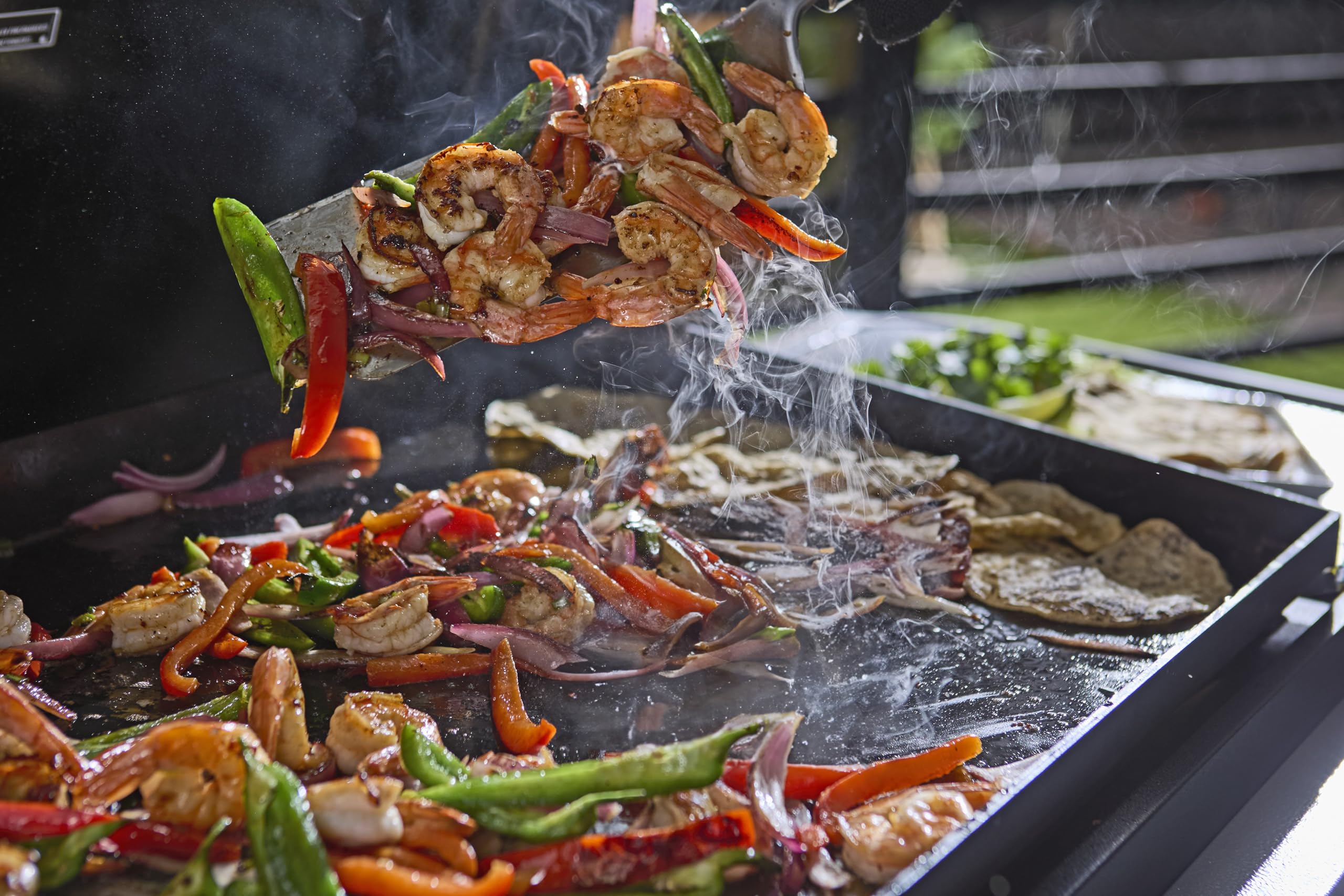 Weber spatulas in use on griddle flipping pancakes for faster, cleaner cooking