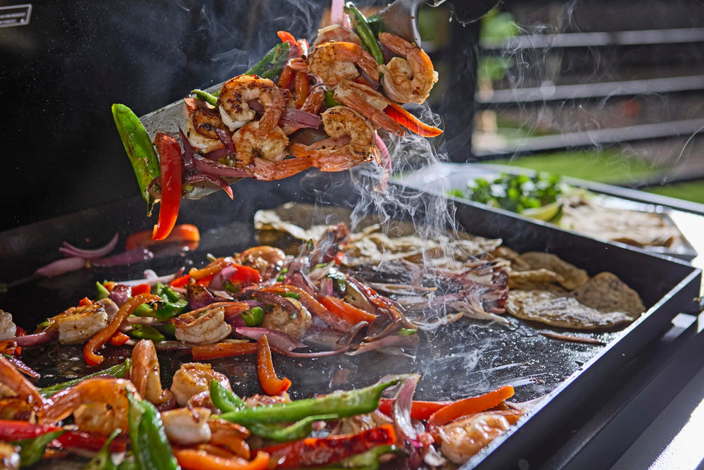 Weber spatulas in use on griddle flipping pancakes for faster, cleaner cooking