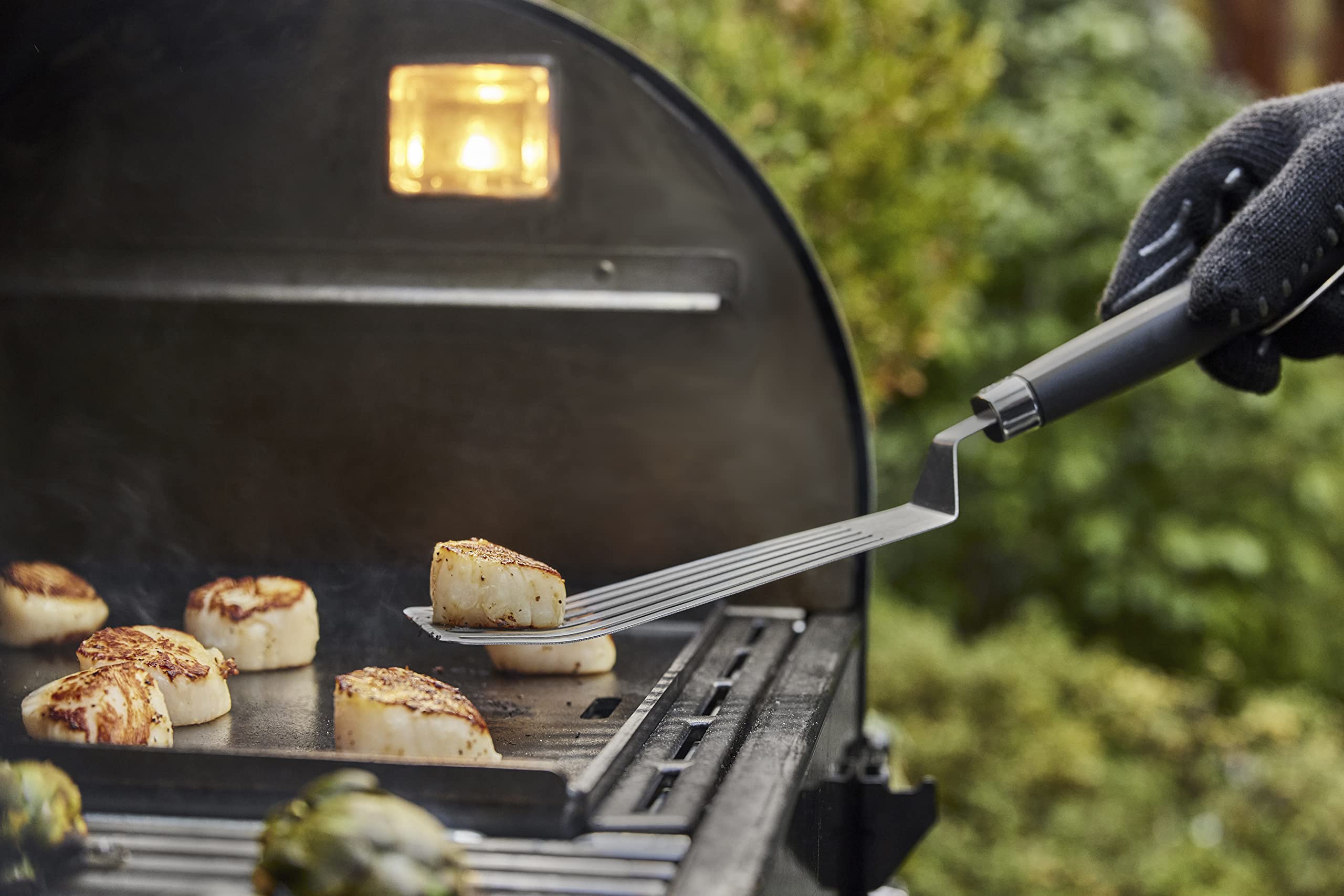Weber tools in use flipping burgers showing stable grip and easy turning