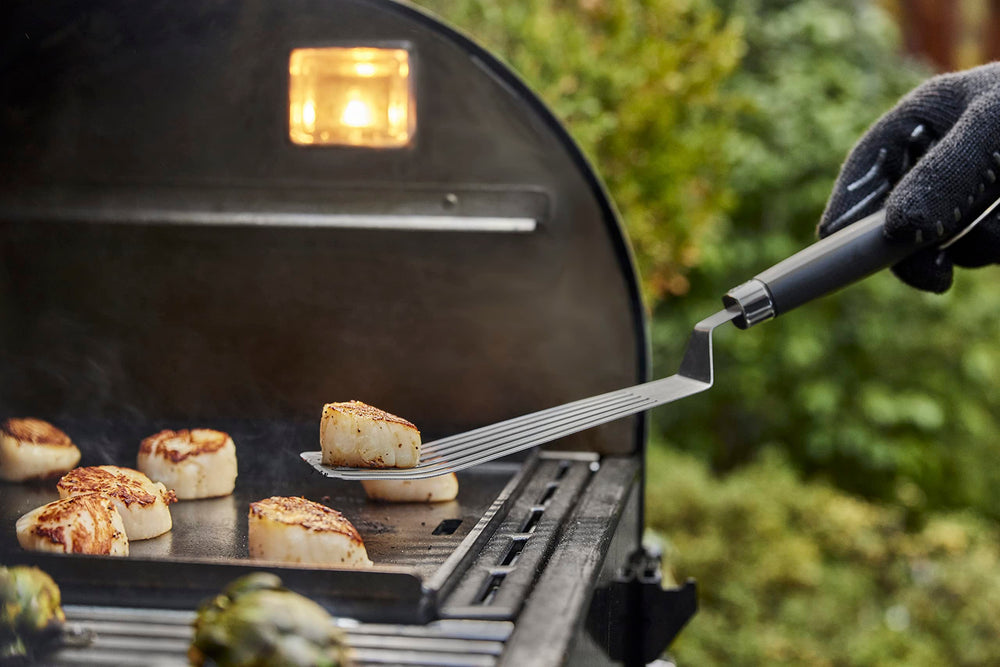 Weber tools in use flipping burgers showing stable grip and easy turning