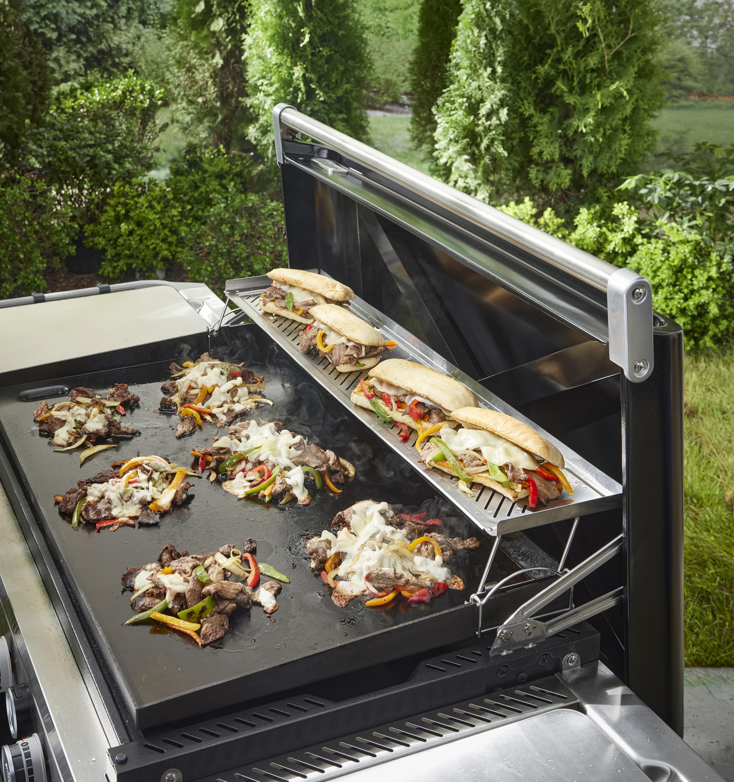 Weber warming rack holding tray full of scrambled eggs to keep food warm and ready