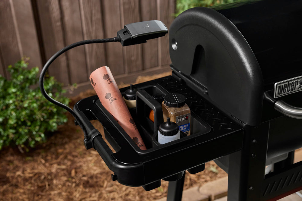 Weber Flex Light held in hand to show compact size and portability