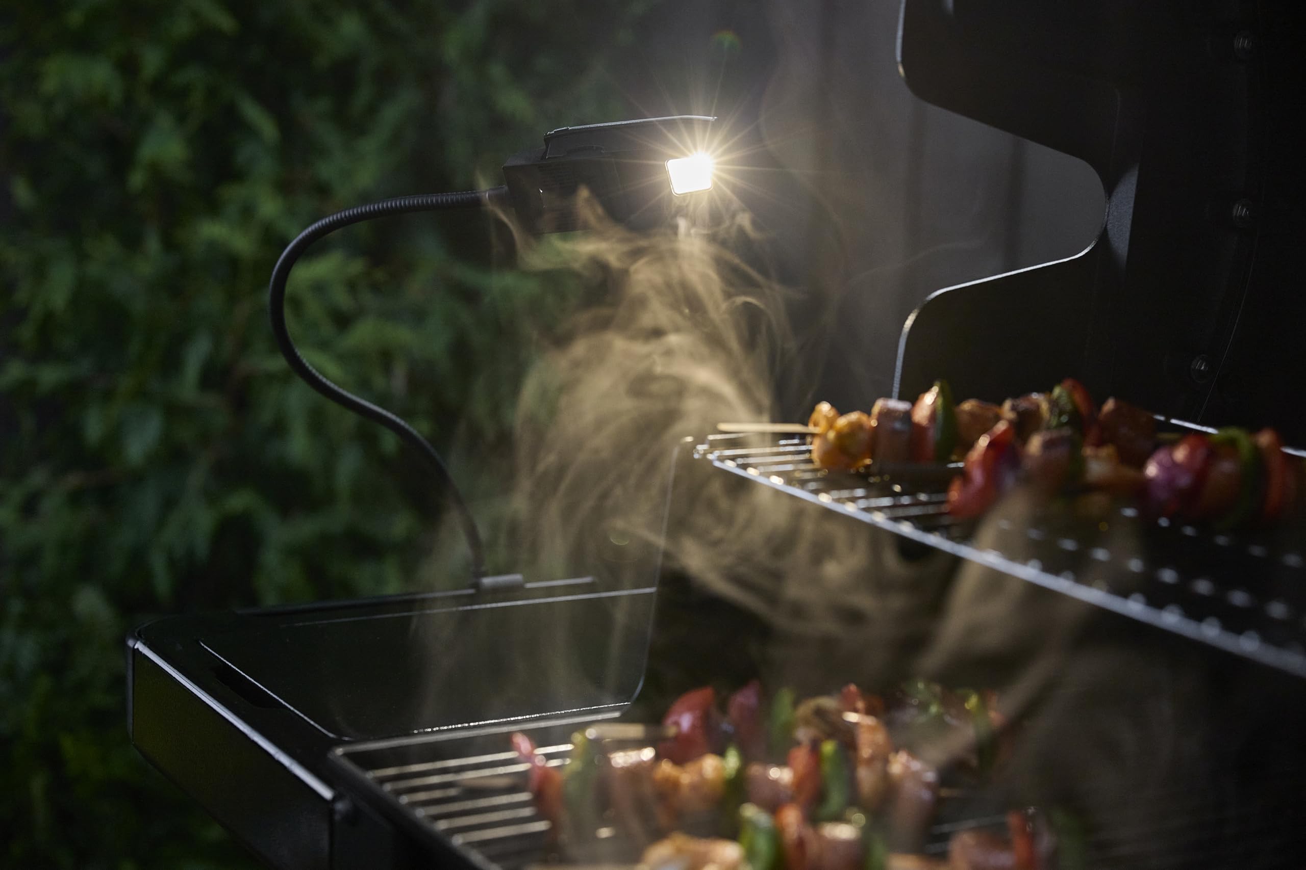Weber clip attaching Flex Light to side table for secure hands-free lighting