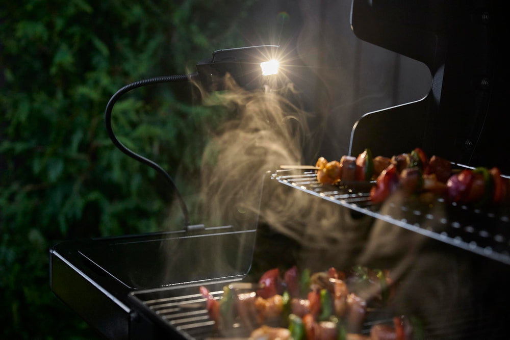 Weber clip attaching Flex Light to side table for secure hands-free lighting