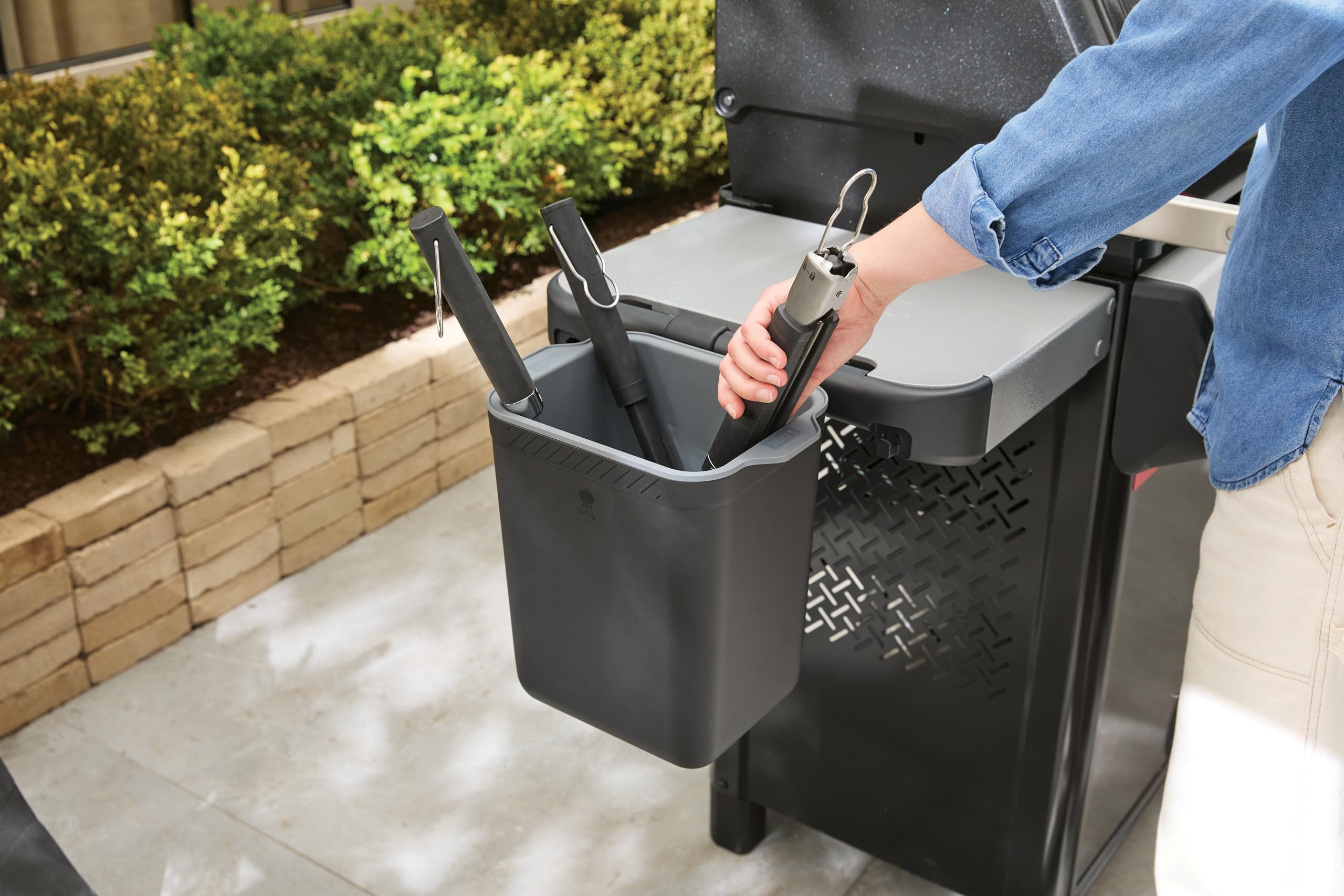Weber tool holder on grill side in outdoor setting for tidy prep area