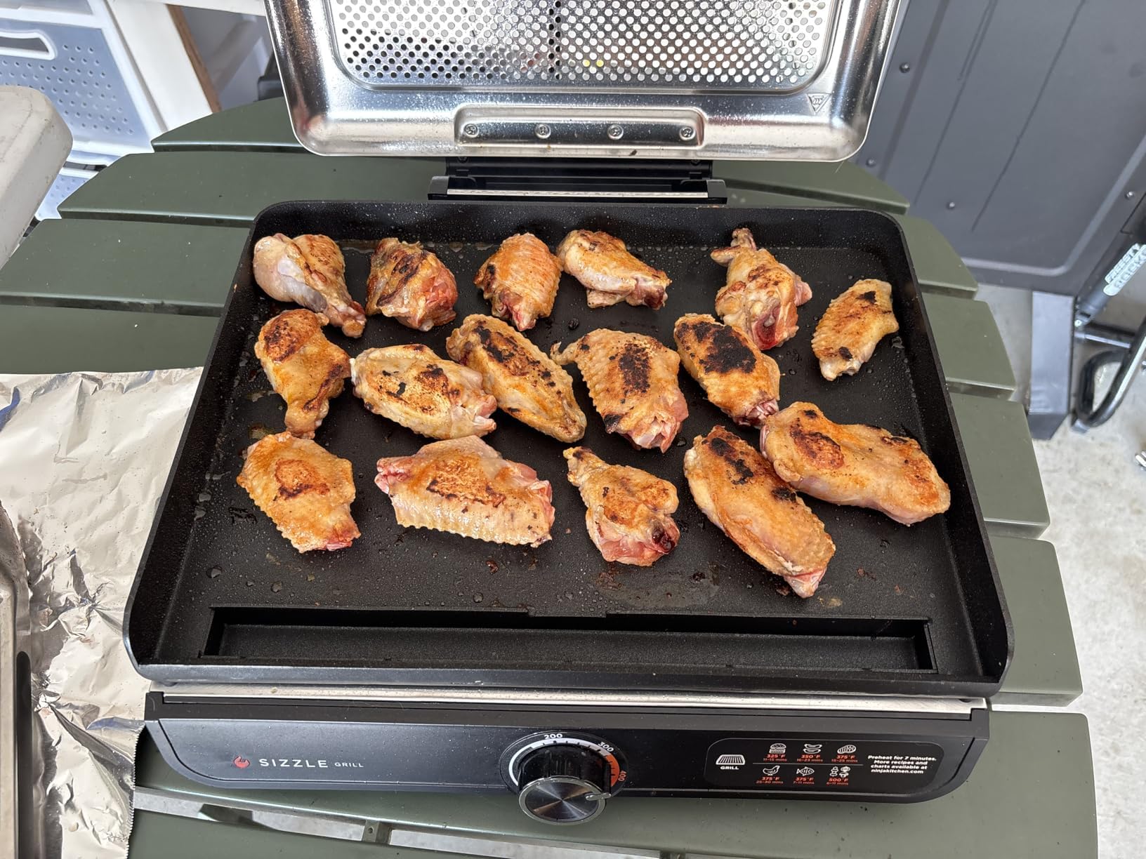 WEBROIL griddle being wiped clean showing easy maintenance benefit