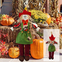 Wedfull scarecrow beside pumpkins in yard creating festive autumn atmosphere