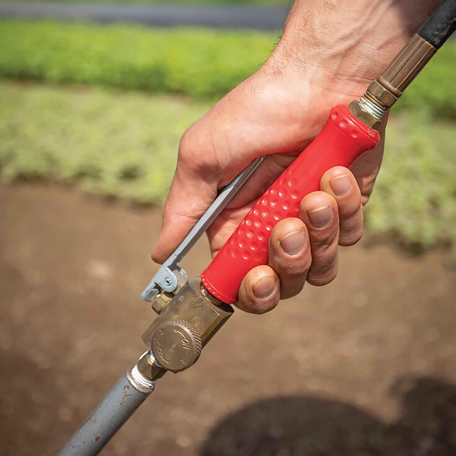 Weed Dragon torch in use on driveway demonstrating fast ice and weed removal