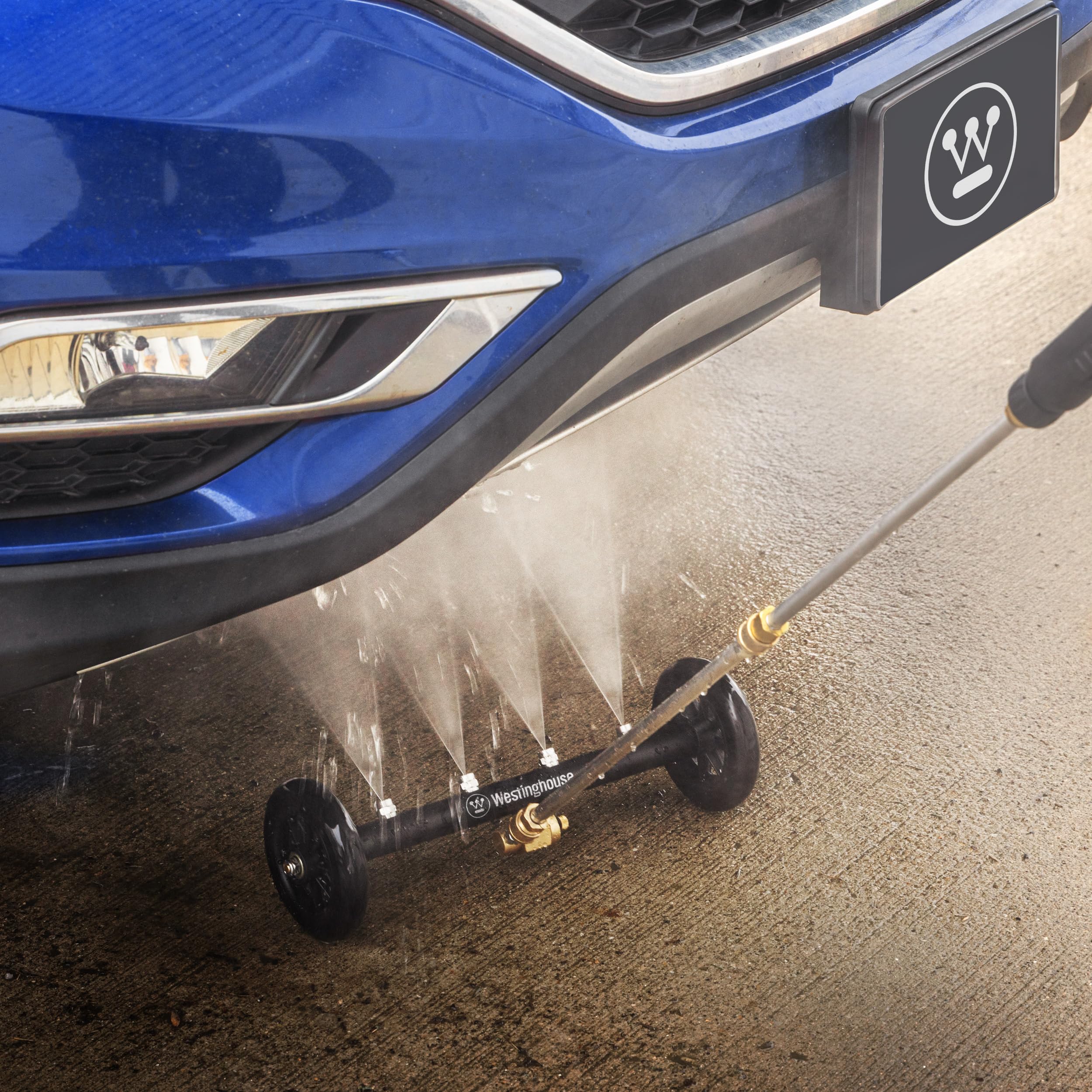 Westinghouse water broom sweeping a driveway for faster debris and oil removal