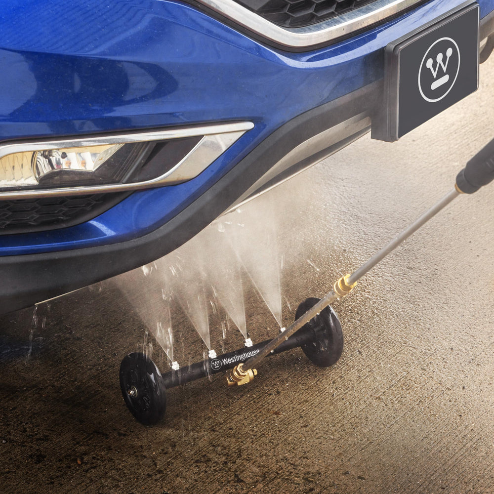 Westinghouse water broom sweeping a driveway for faster debris and oil removal