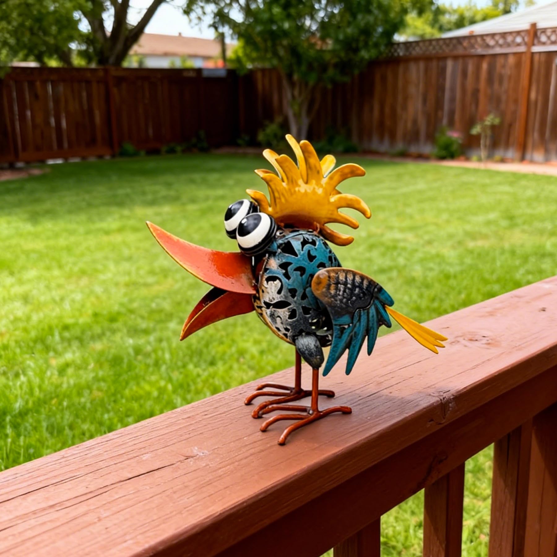 WHBIMGOOO metal bird placed in garden bed adding whimsical focal point to plants