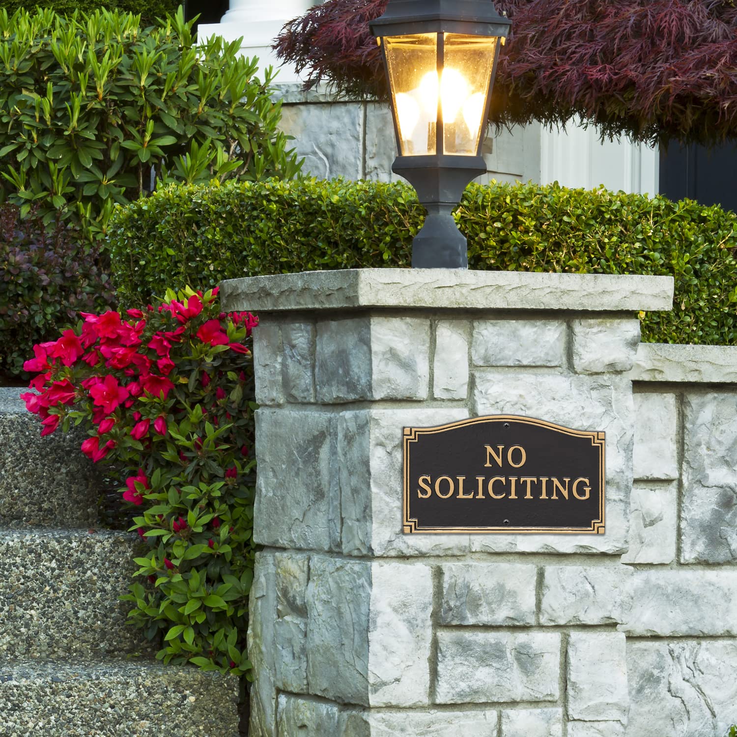 Whitehall plaque installed in a garden near a path showing professional curb appeal and durability