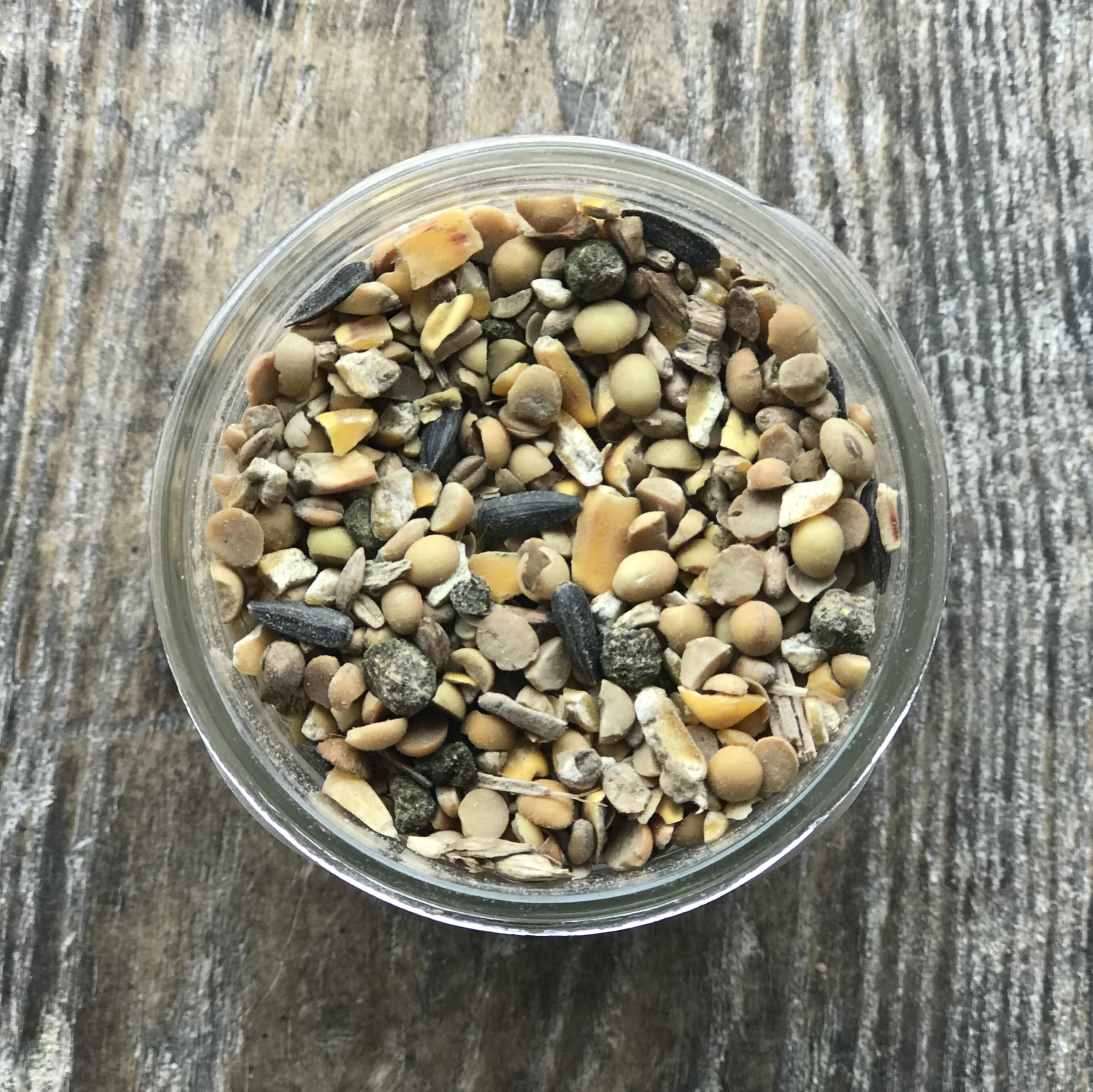 Wholesome Harvest bag opened with visible whole non-GMO grains and nutrient-rich mix