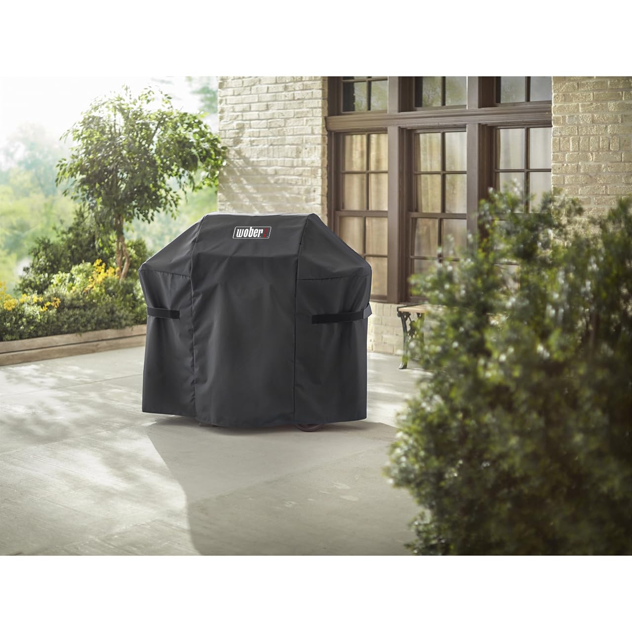 WOBER COVER on an outdoor grill in a patio scene protecting from rain and dust