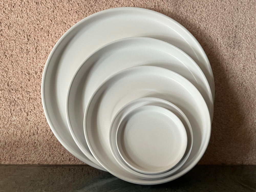 Woiida saucer with water pooling demonstrating catchment to protect floors